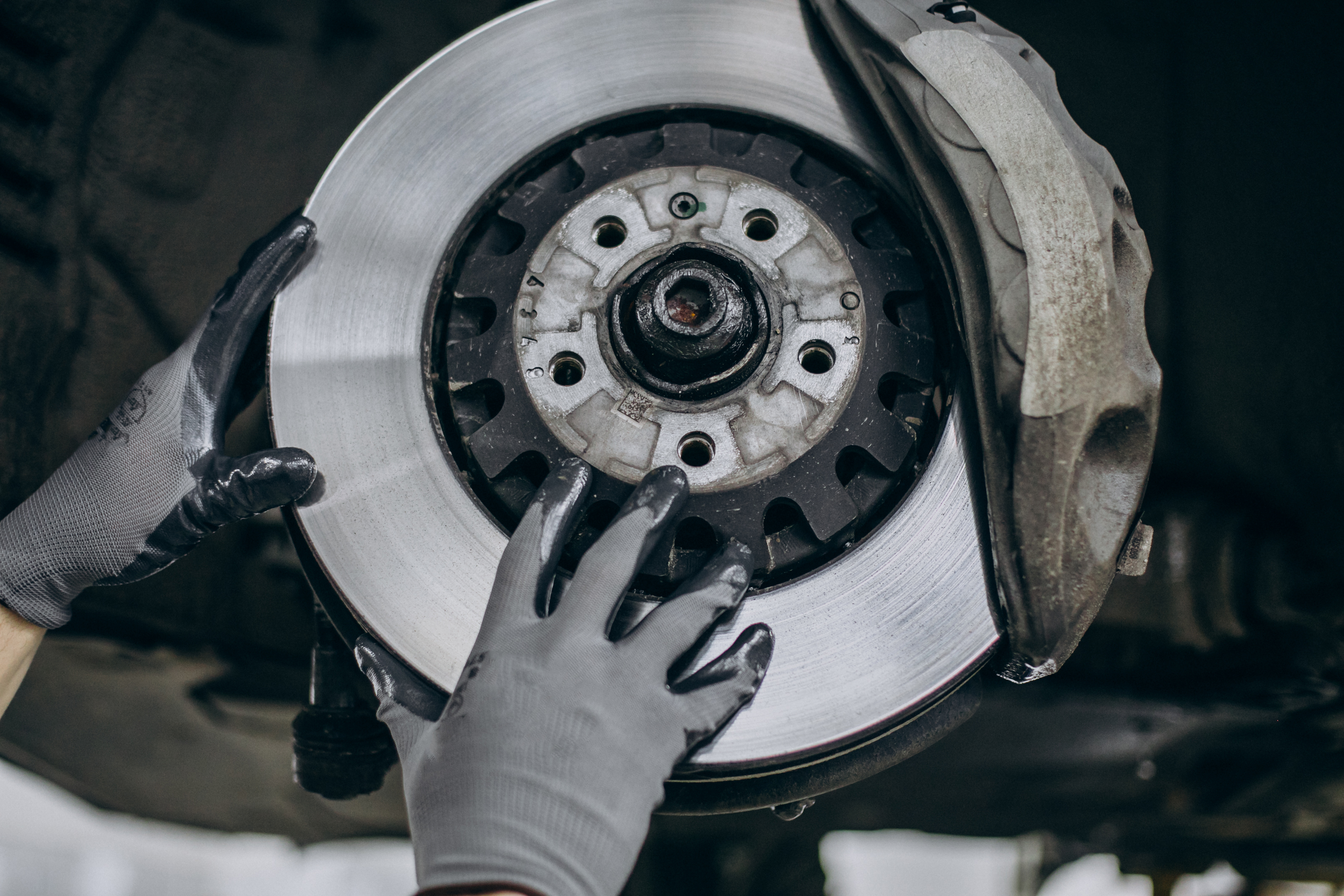 Close-up of a vehicle brake disc and caliper during brake servicing