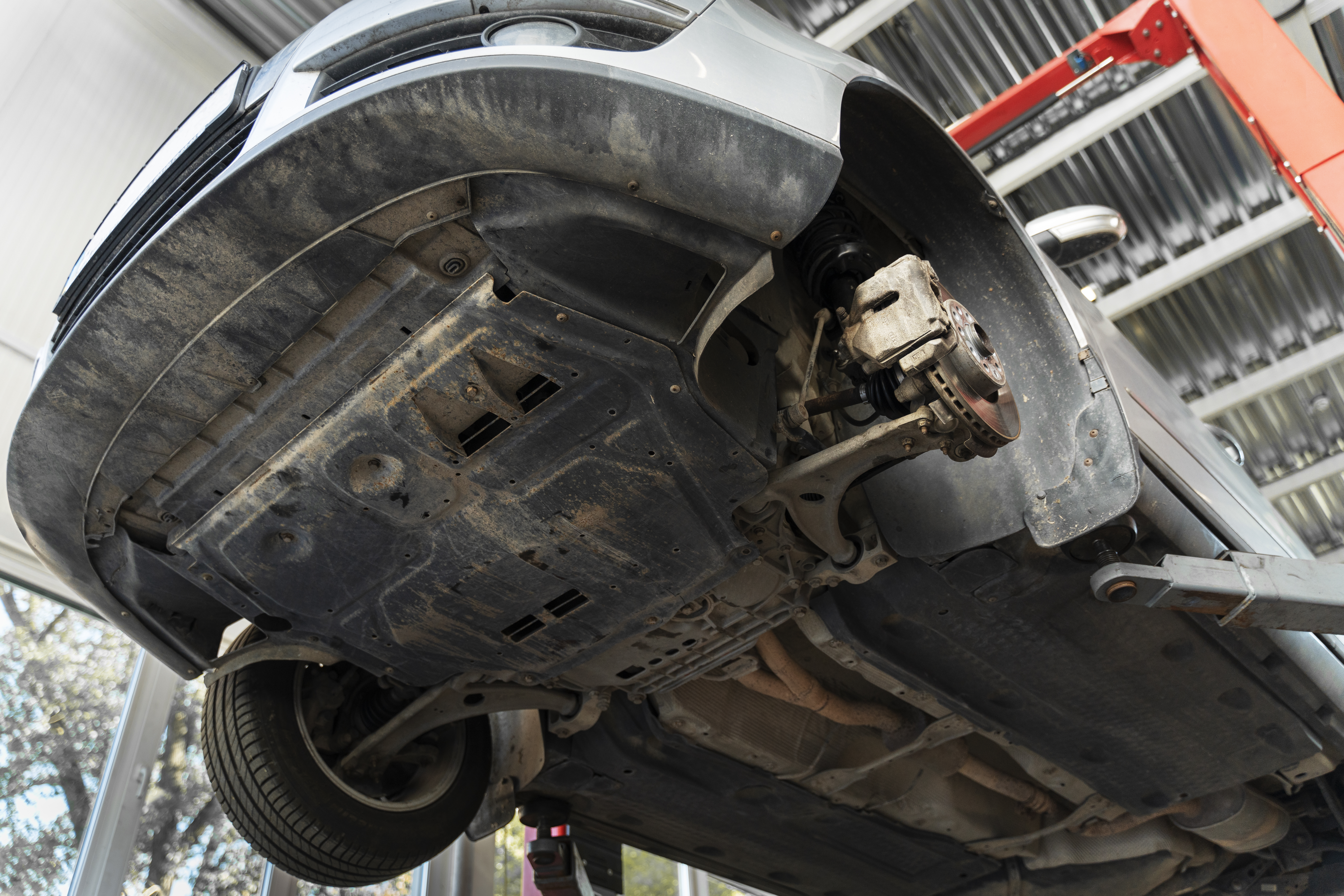 Car raised on a workshop lift for MOT preparation and safety inspection